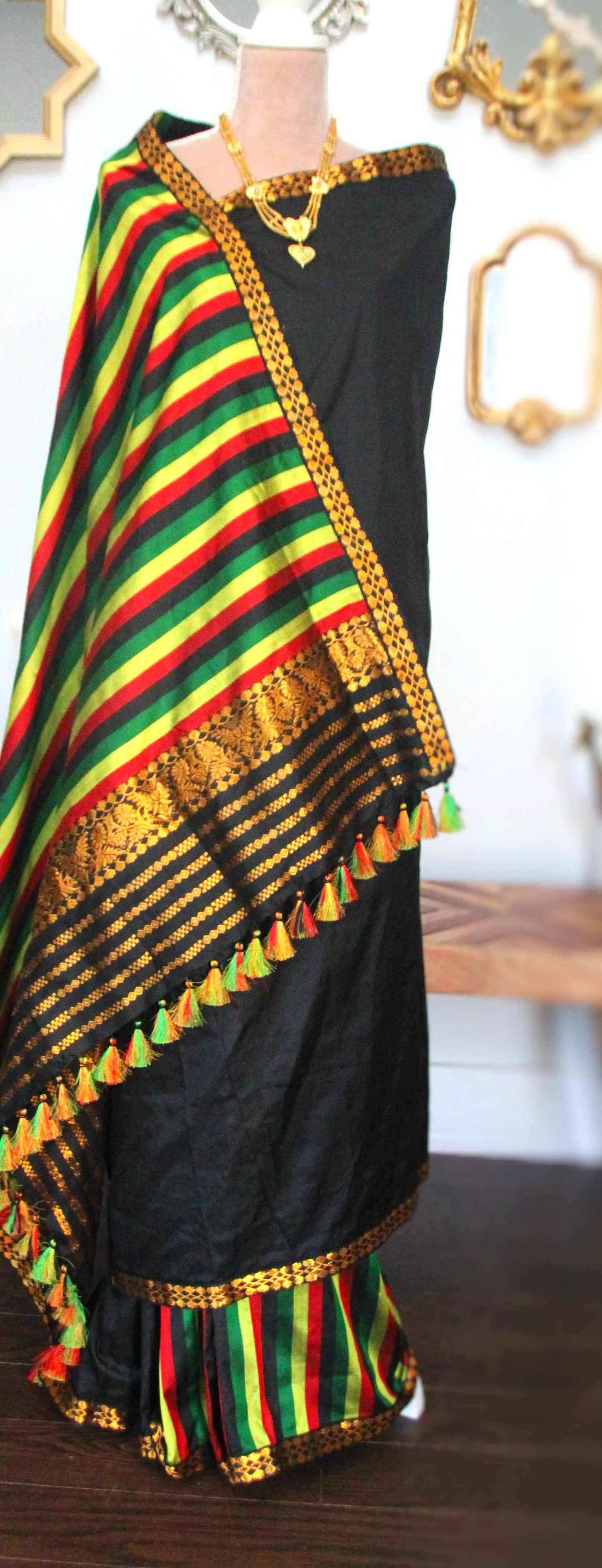 Black Assam silk saree with golden boarder and stripes on the pleats section and the achal