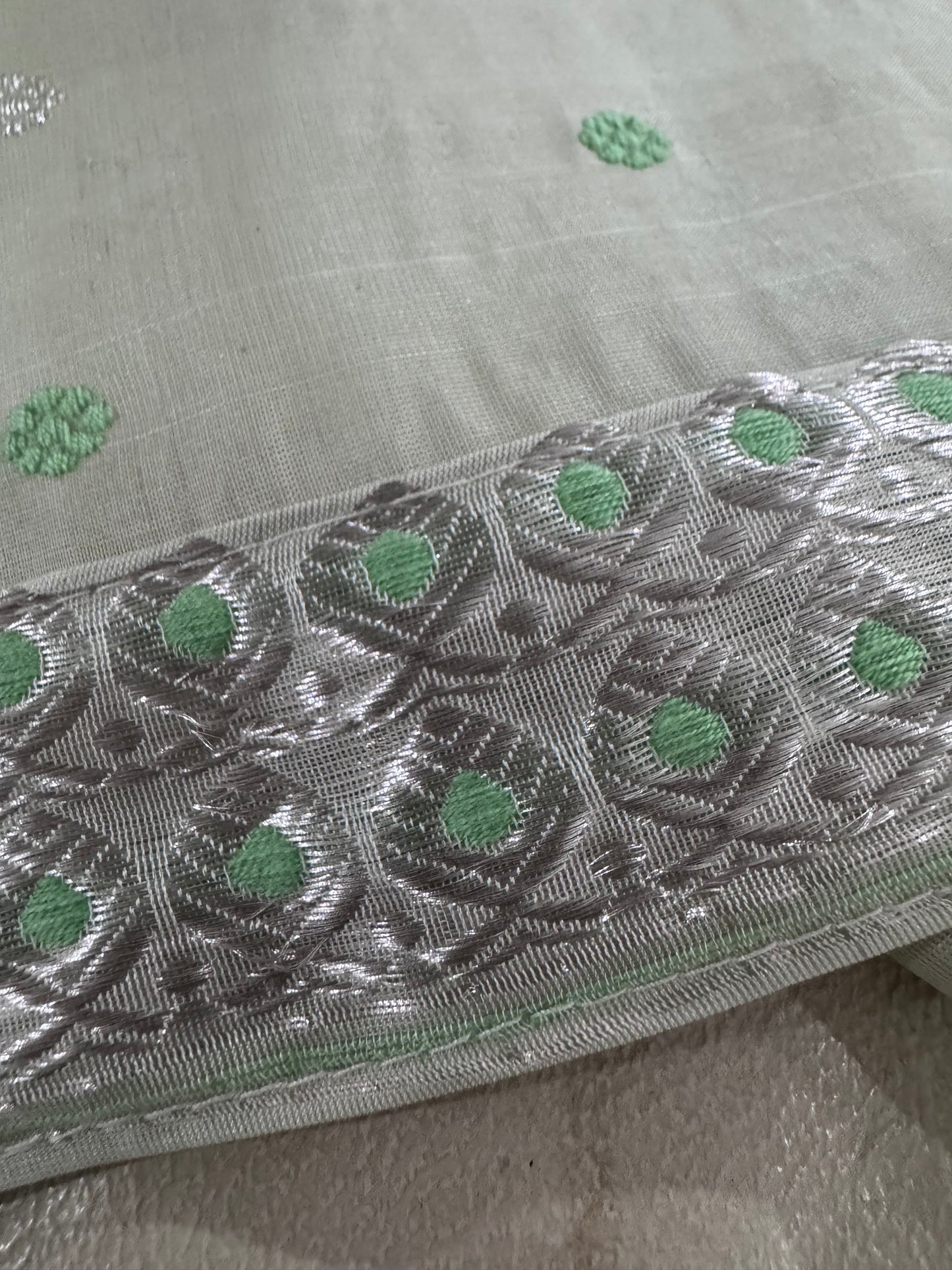 Mint Green Mekhela chadar and silver work heavy boarders and dotted buttis all over
